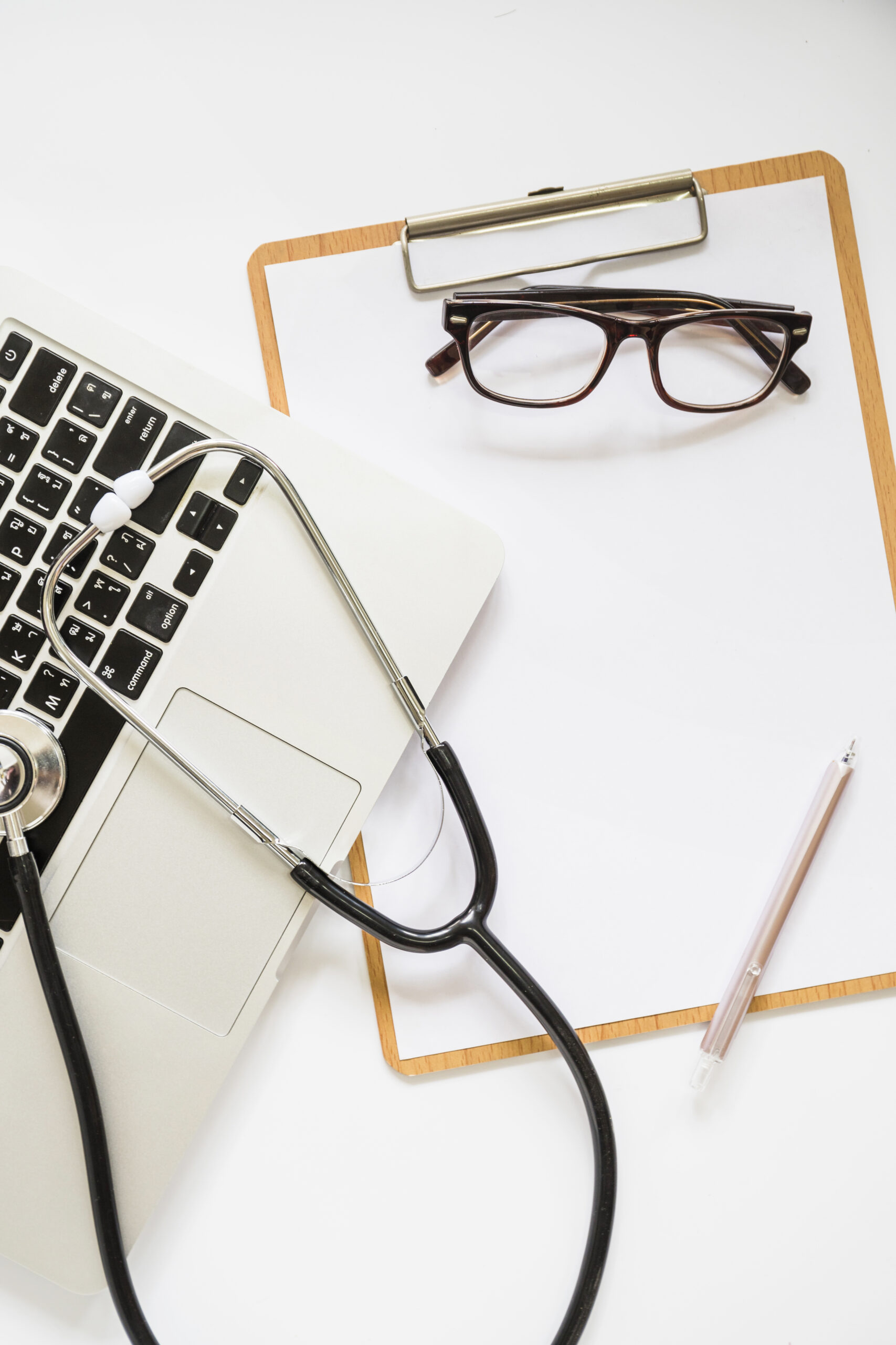 Stéthoscope posé sur un ordinateur portable, symbolisant le diagnostic littéraire comme une analyse approfondie d'un texte.